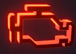 Illuminated red check engine light icon on a car dashboard.