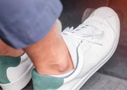 Driver pressing clutch pedal — one of the bad driving habits that ruin your engine.