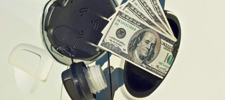 The Impact of Gas Prices on Car Purchases and Ownership Costs. Rising gas prices impact car ownership costs with dollar bills in a fuel tank.