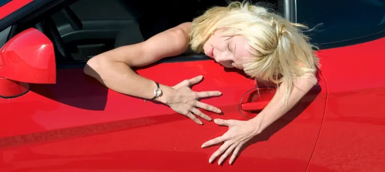 New Car Owner Expressing Love for Her Vehicle. Excited new car owner hugging her red car in joy.