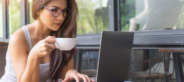 Secure the Best Deal in Your Area with Our New Car Price Quote Tool. Young lady on her computer requesting a free car price quote to find the best deal on a vehicle she would like to purchase.
