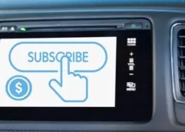 Car dashboard screen displaying a "Subscribe" button, representing vehicle feature subscriptions in 2025.