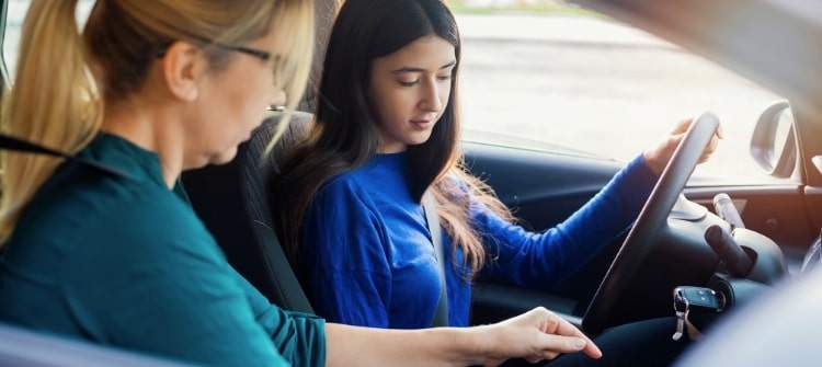 How to Make the Best Decision When Getting a Car for a Teenager. A parent and teenager discussing the features of a car, highlighting safety and affordability.