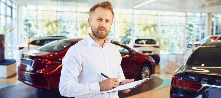Car Salesman Evaluating Buyers in a Dealership. Car dealership salesman assessing car buyers likely to get worst deals.