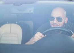 Bald man driving aggressively ignoring unwritten road rules.