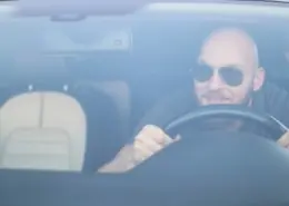 Bald man driving aggressively ignoring unwritten road rules.