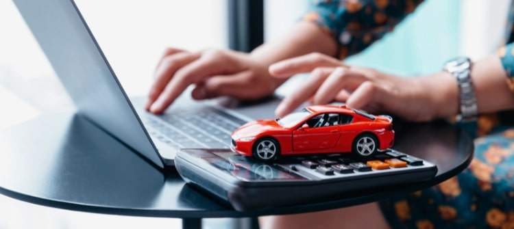Comparing Auto Loan Offers After Pre-Qualification. Online car loan pre-qualification with calculator and toy car.