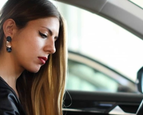 Woman wondering if she should buy or lease a new car.